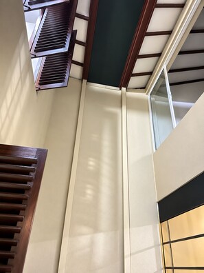 A staircase with wooden handrails and a white wall. - Private Designer 3BR Villa in Battaramulla | Sleeps 7 | Near Colombo (Battaramulla)