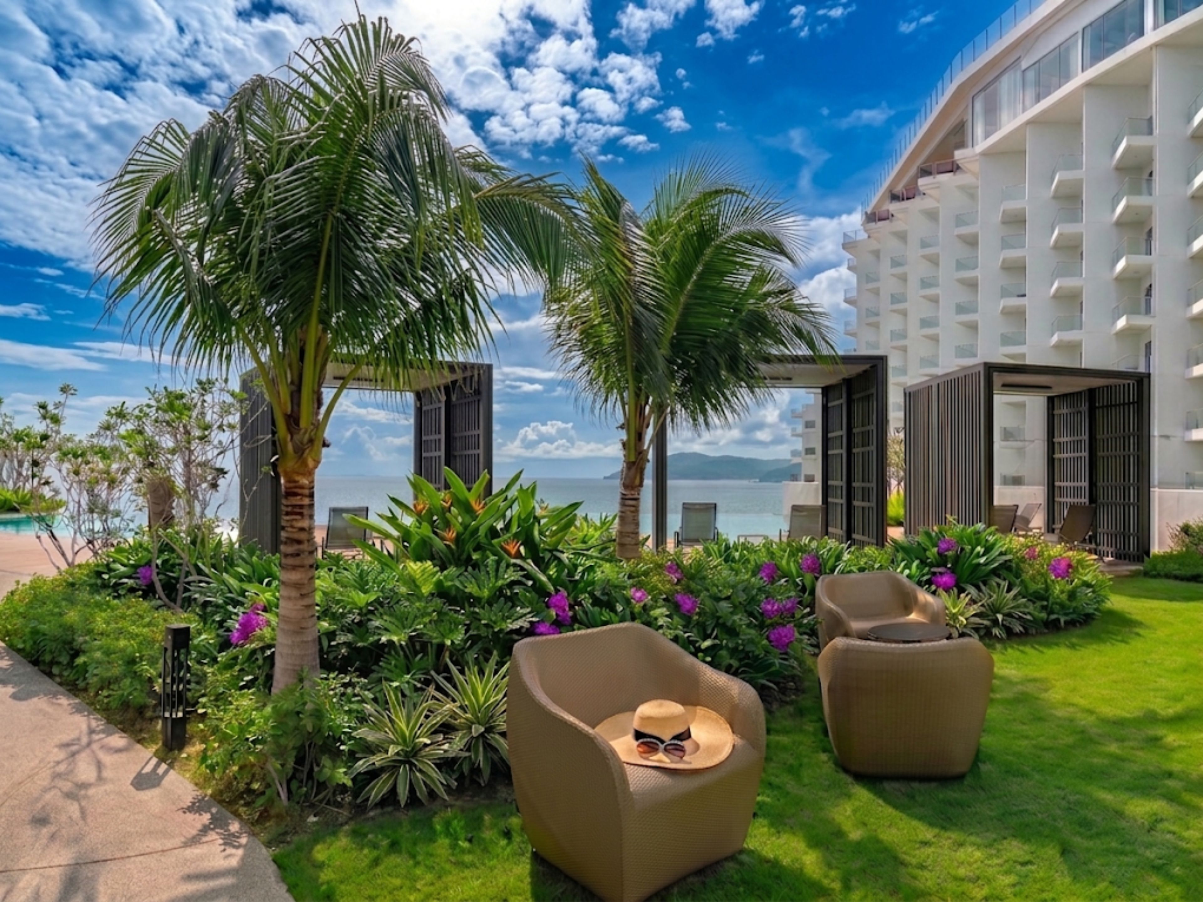 A modern outdoor area with a pool, palm trees, and lounge chairs.