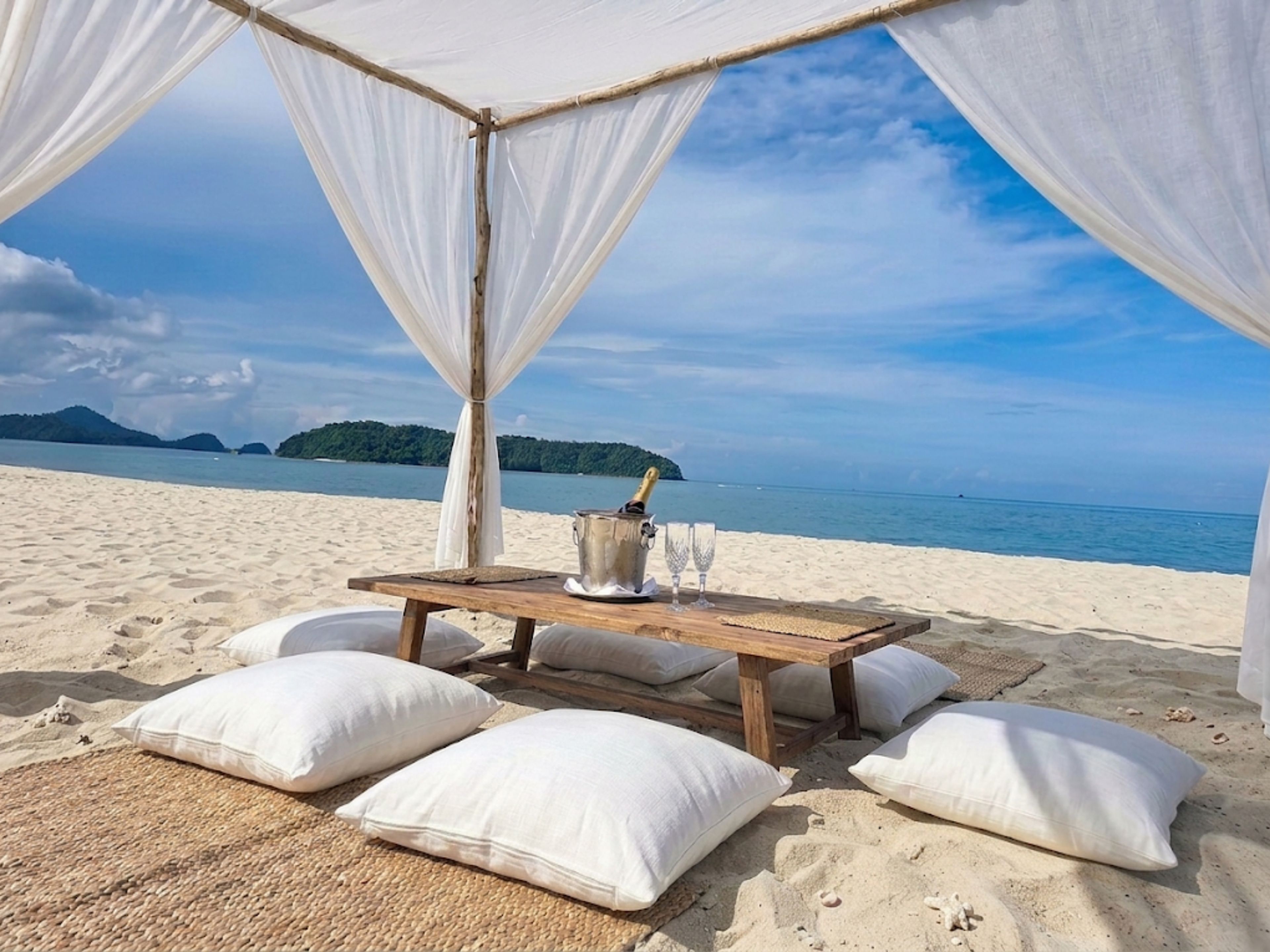 Private beachfront cabana dining with ocean views and island scenery