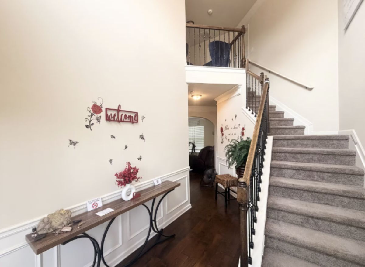 A staircase with a handrail and carpeted steps leading to a landing.