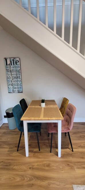 A dining area with a table, chairs, and a staircase. - Unique and stylish, recently renovated house (Southampton)