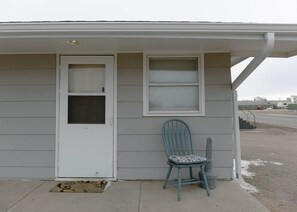 A single-story house with a white door and a window.