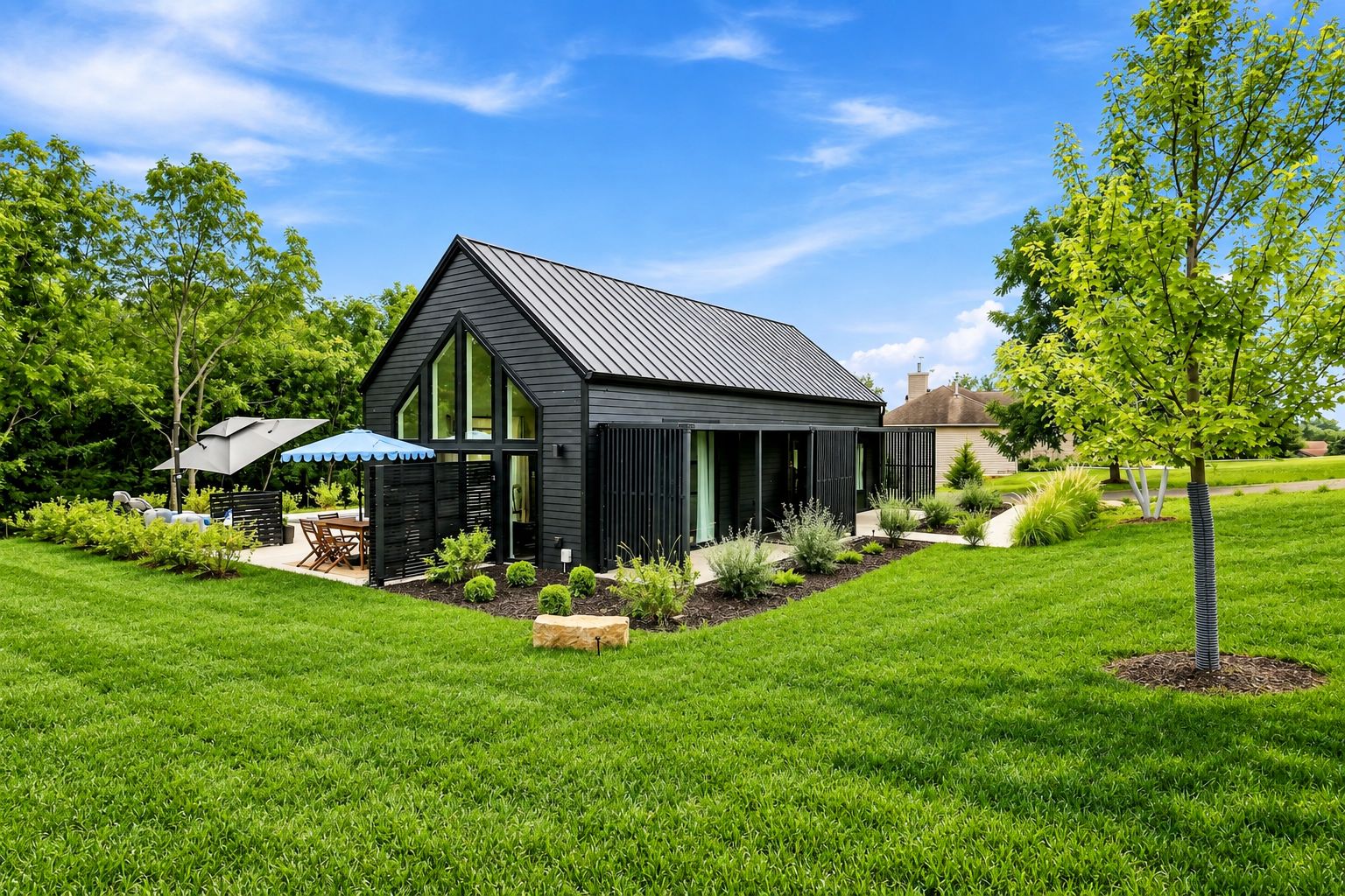 A modern house with a sloped roof, surrounded by a well-maintained lawn and garden.