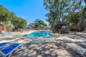 A swimming pool with lounge chairs and a paved deck. - Shelley by the Seas  Beach Escape in N. Myrtle Beach, 3-bedroom house (North Myrtle Beach)