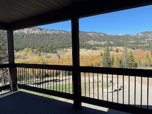 A covered outdoor area with a view of a mountainous landscape. - Luxury Montana Cabin on Rocky Mountain Front-Entrance to Bob Marshall Wilderness (choteau)