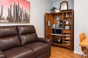 Relaxed seating meets a cleverly organized cabinet stocked with essentials.