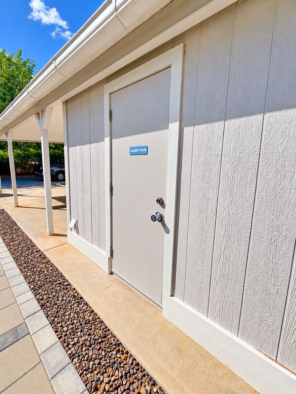 A building with a door labeled 'Laundry Room' and a keypad lock.