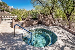 A swimming pool with a blue border, surrounded by a concrete deck, and shaded by trees. - Cozy 1-bedroom condo in the beautiful Catalina Foothills of Tucson. (Tucson)