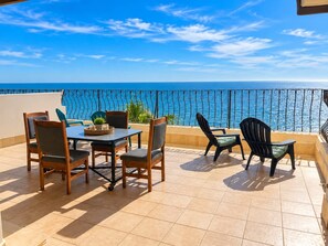 A terrace with a table and chairs, a view of the sea, and a railing. - Puerto Viejo C-3 | Waterfront 3BR on the Malecón (Puerto Peñasco)