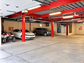 A multi-level parking garage with red structural supports, labeled parking bays B3 and A1, and a white car and SUV parked in bay B3. - Puerto Viejo C-3 | Waterfront 3BR on the Malecón (Puerto Peñasco)