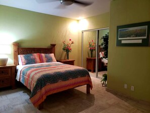 A bedroom with a bed, nightstands, a mirror, and a wall-mounted picture. - Puerto Viejo B-2 | Oceanview 3BR on the Malecón (Puerto Peñasco)