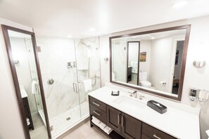 A modern bathroom with a glass-enclosed shower, a large mirror, and a white vanity with dark cabinets. -  Snowbird Cliff Club Time Share Cx week Sat Dec 19 4pm - Sat Dec-26 -Dec 10am (Sandy)
