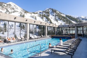 A pool area with lounge chairs and a view of snow-covered mountains. -  Snowbird Cliff Club Time Share Cx week Sat Dec 19 4pm - Sat Dec-26 -Dec 10am (Sandy)