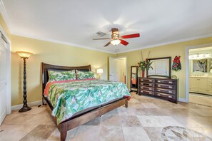 A bedroom with a bed, a dresser, a mirror, and a ceiling fan. - Escape to your private Poolside Paradise - Backyard Oasis w/pool & palapa.  Min (Galveston)