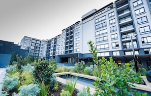A modern multi-story building with balconies and large windows. - Cozy 1-bedroom apartment in adorable Santiago with fitness room (Santiago)