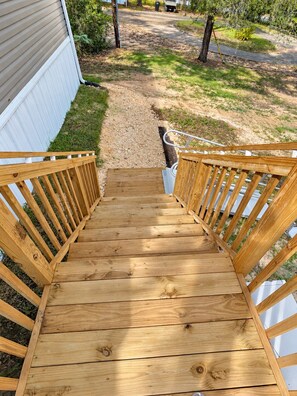 A wooden outdoor staircase leading to a house. - Marie's Hideaway (Keystone Heights)