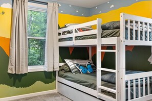 A bunk bed room with a window, curtains, and a wall mural. - Hilltop Hideaway · Sleeps 9 · Near Lake Hayward & Mohegan Sun (Colchester)