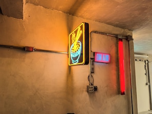 A neon sign with a bowl of noodles and a red 'ON AIR' sign on a wall. - Romantic Studio at Mirante do Vale | Bathtub + 120" Cinema @cheng.du11 (São Paulo)