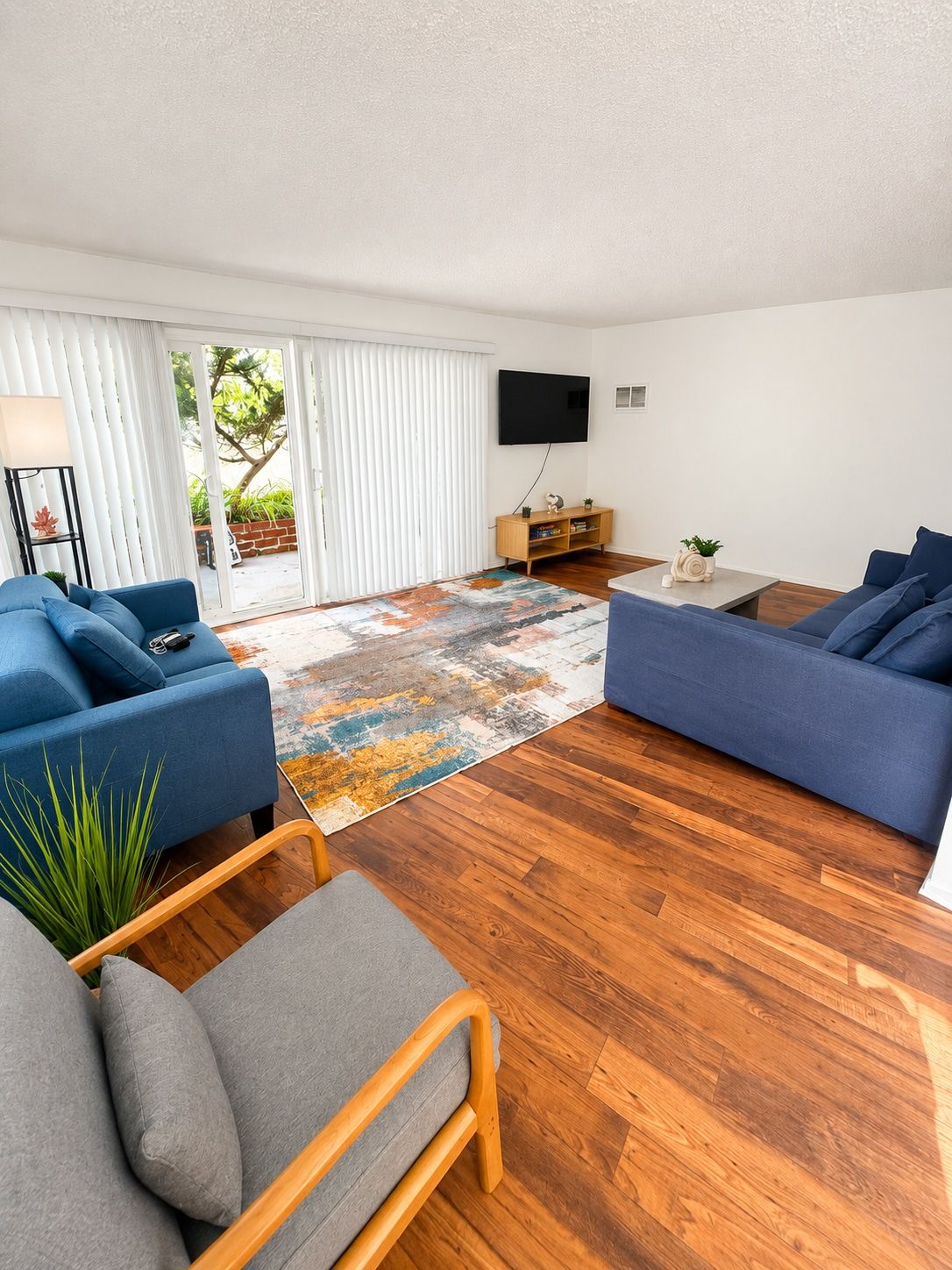 A modern living room with two sofas, a coffee table, and a TV.