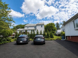 A two-story residential building with a driveway parking two cars. - Newly Renovated 3BR Private Home in Newton (Newton)