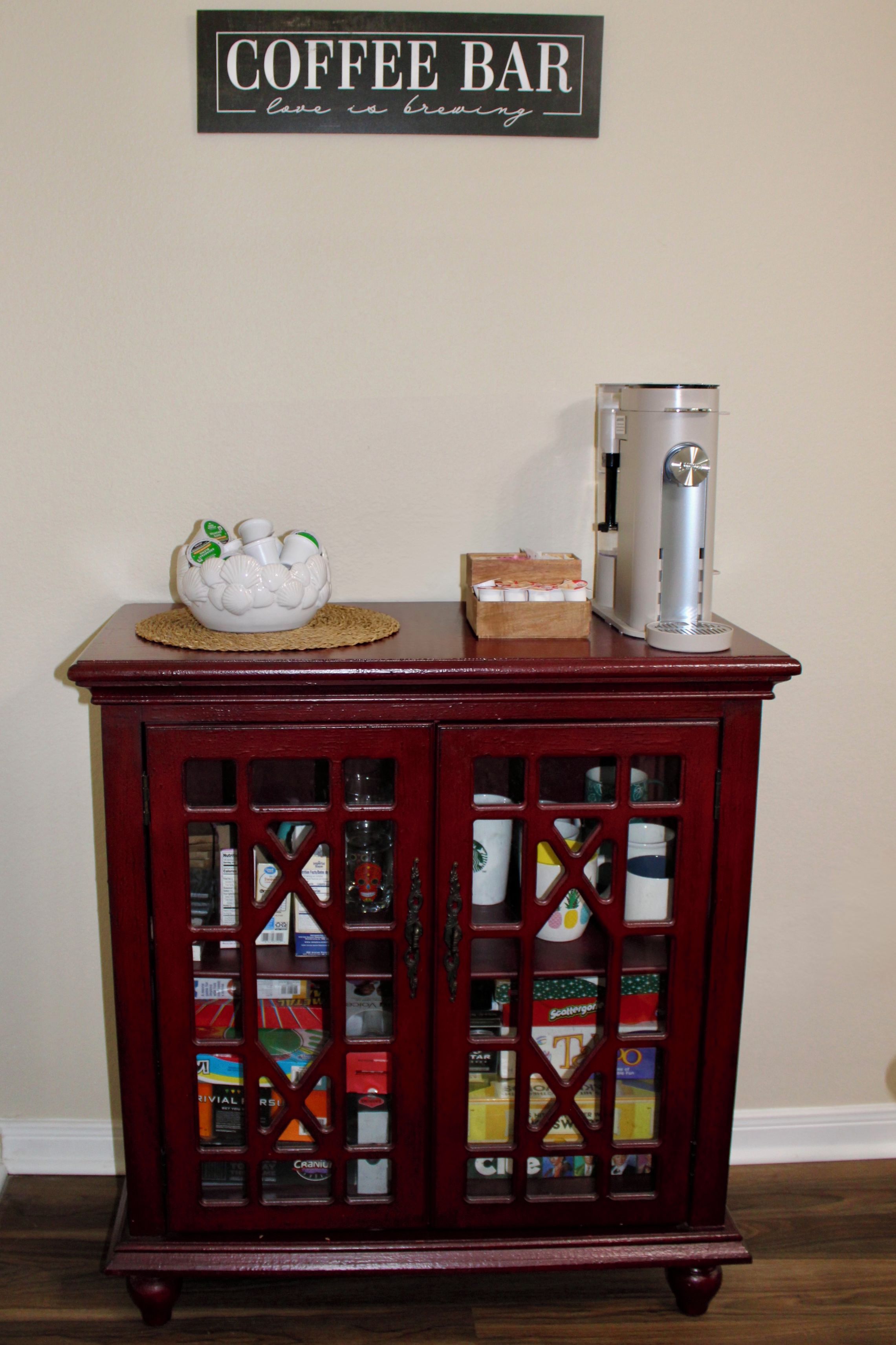 A coffee bar with a sign above, a decorative bowl, and a coffee machine.