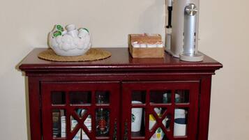 A coffee bar with a sign above, a decorative bowl, and a coffee machine.