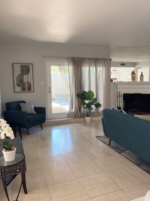 A living room with a sofa, a chair, a coffee table, and a potted plant. - 2-bedroom Wellness/Golf Retreat in Scottsdale (Scottsdale)