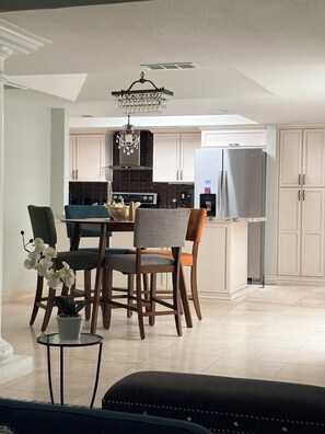 A modern kitchen with white cabinetry, a black countertop, and a stainless steel refrigerator. - 2-bedroom Wellness/Golf Retreat in Scottsdale (Scottsdale)