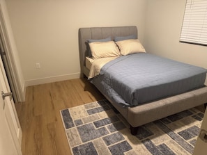 A bedroom with a bed, a headboard, a rug, and a window with blinds. - Desert Ridge Resort-Style 2 BR, Near JW Marriott (Phoenix)