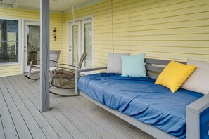 A covered porch with a wooden bench and a swing chair. - Wonderful 6-bedroom estate with pool in charming Bagdad, KY. (Bagdad)