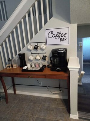 A coffee bar setup with a Keurig coffee maker, mugs, and a sign that reads 'Coffee Bar'. - Beautiful Tri-Level. Spacious Comfort for Families and Groups. (El Paso)