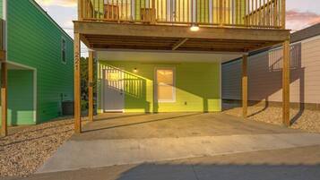 A two-story house with a balcony, a garage, and a driveway.