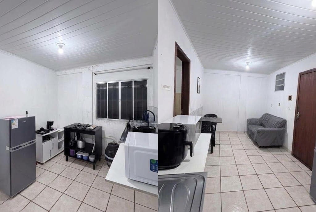 Cocina compacta con refrigerador, estufa, microondas y una pequeña mesa de comedor.