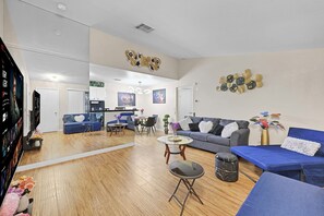 A spacious living area with a sofa, coffee table, and a dining table. - #NEW# LUXURIOUS 2BR/2BA WITH FULL ACCESS TO ALL PALMS RESORTS 2 POOLS & HOT TUB (Las Vegas)