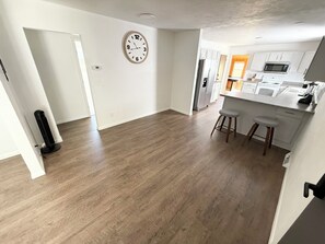 A modern kitchen with white cabinets, a microwave, and a stainless steel refrigerator. - Tremendous 2-bedroom beside Keystone State Park New Alexandria (New Alexandria)
