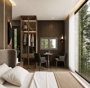 A modern bedroom with a bed, a seating area with chairs, a wardrobe, and a window with a view of trees. - Private 1BR Mountain Cabin with Hot Tub & Forest Views (Menlo)