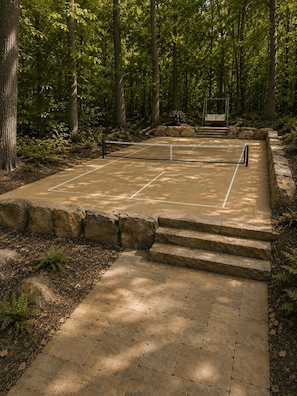 A tennis court surrounded by stone steps and a forested area. - Private 1BR Mountain Cabin with Hot Tub & Forest Views (Menlo)