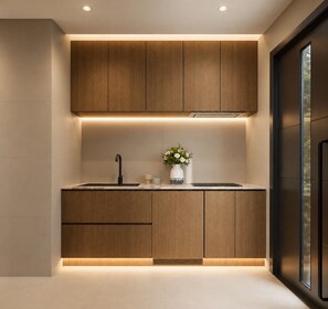 A modern kitchen with wooden cabinets, a black faucet, and a vase with flowers. - Private 1BR Mountain Cabin with Hot Tub & Forest Views (Menlo)