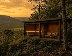 A modern cabin with a glass enclosure, wooden interior, and a view of the surrounding landscape. - Private 1BR Mountain Cabin with Hot Tub & Forest Views (Menlo)