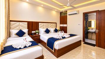 A hotel room with two beds, a wooden headboard, a built-in wardrobe, a bathroom with a marble sink, and an air conditioning unit.