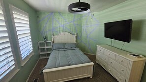 A bedroom with a bed, dresser, TV, and a window with blinds. - Beautiful 5-bedroom house with a beautiful mountain views. (North Ogden)