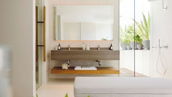 A modern bathroom with a wooden vanity, a large mirror, and a shower area. - NoKu Beach House - Beachfront 6BR Seminyak Villa, Sunsets & Full Staff (Badung)