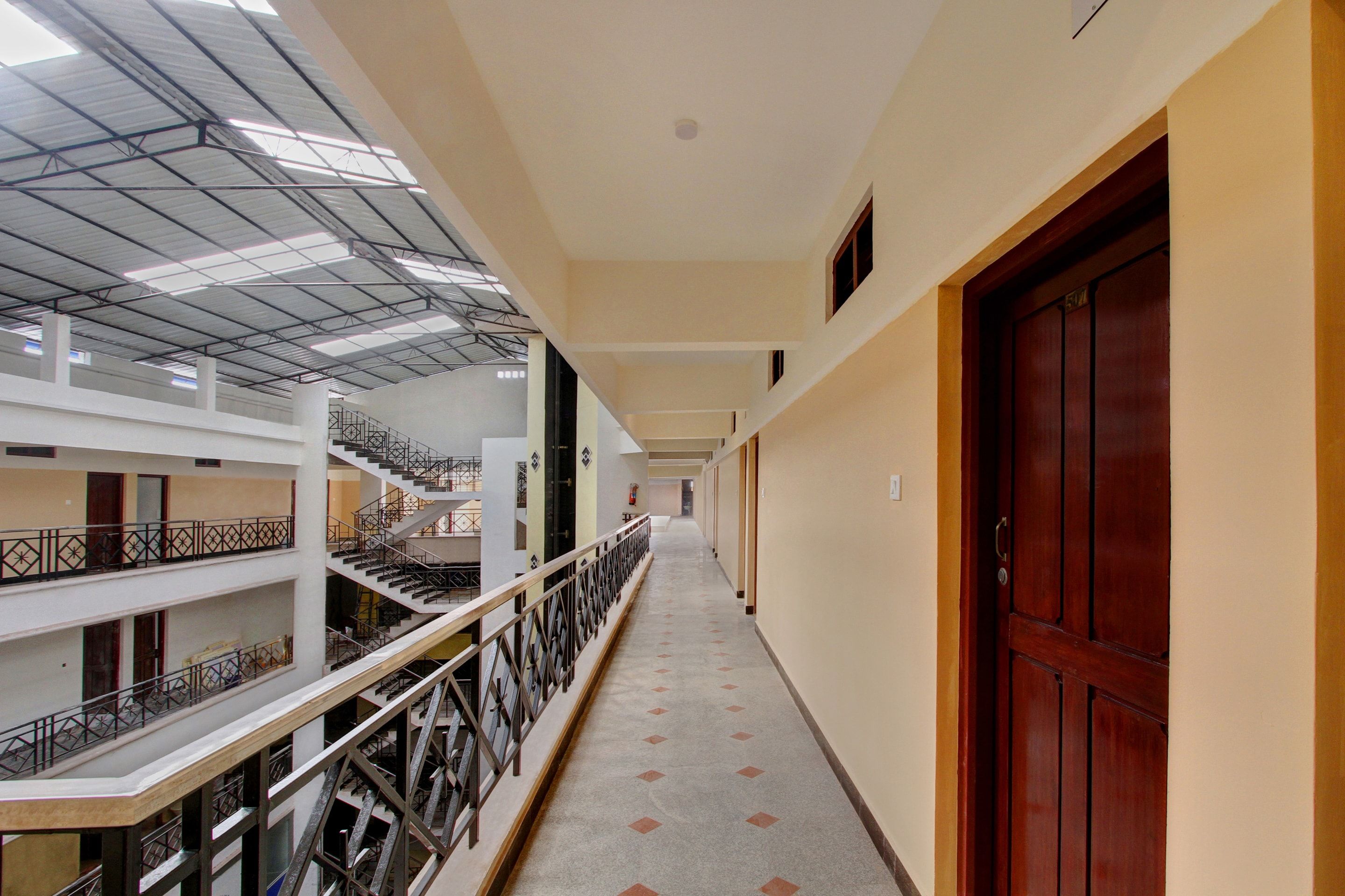 A multi-level corridor with a staircase on the left and a door on the right.