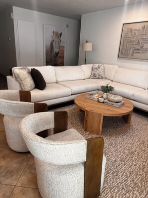 A living room with a beige sectional sofa, two armchairs, a coffee table, and a rug. -     Resort-Style Desert Oasis + Pool & Spa (Bermuda Dunes)