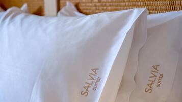 A white pillow with the text 'SALVIA SUITES' printed on it.