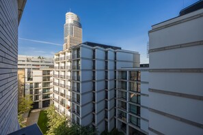 Ein mehrgeschossiges Gebäude mit modernem architektonischen Design, das Balkone und große Fenster aufweist.