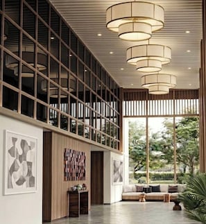 A modern interior with a large window, a sofa, and a hanging light fixture. - Riva River Retreat By Asawann (Nong Khai)