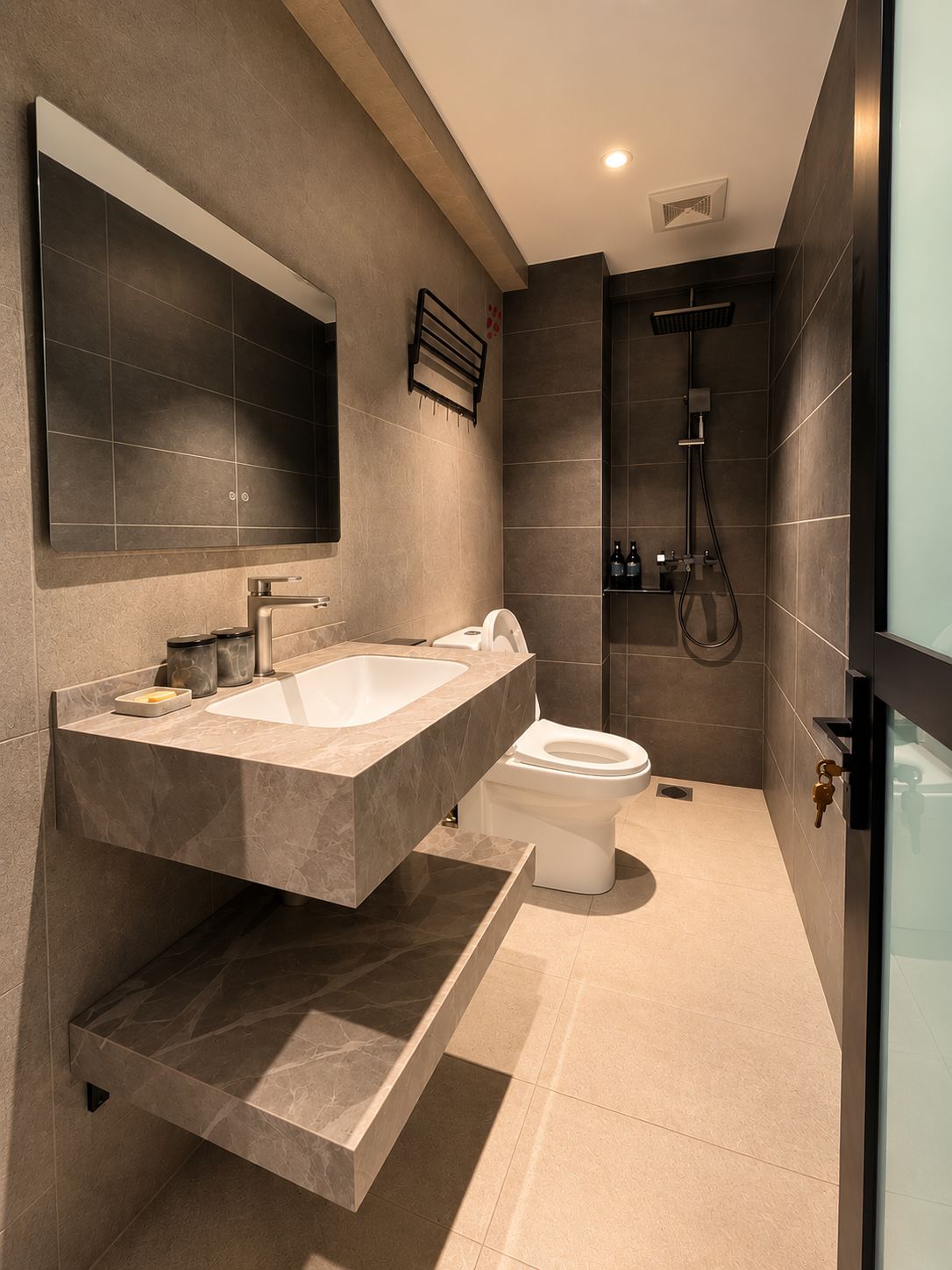 A modern bathroom with a large marble sink, a toilet, and a shower area.