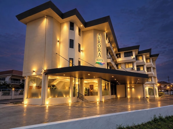 A multi-story hotel with a prominent sign reading 'AURORA SUITE'.