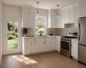 A modern kitchen with white cabinetry, stainless steel appliances, and a window providing natural light. - Spacious & Modern 2 Bed / 1 Bath Suite Ideal Parkside Living! perfect new home (San Diego)